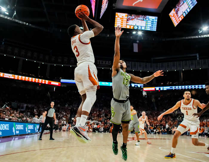 Texas Longhorns guard Max Abmas (3) shoots the ball over defense from Baylor Bears guard Langston Love (13) in the second half of the Longhorns' game against the Baylor Bears at the Moody Center in Austin, Jan 20, 2024. Texas won the game 75-73 with a layup in the final seconds of the game.